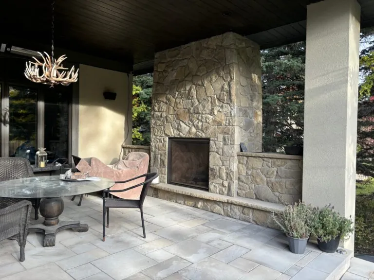 Acreage sandstone fireplace and patio